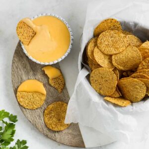 Nacho cheese sauce and nacho crackers presented for serving.